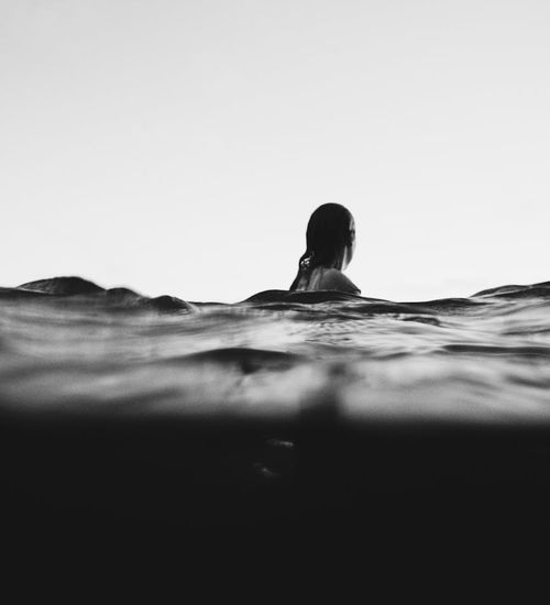 Silhouette of a person meditating against a stylized natural background.